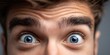 © NovaVision - Close-up extreme shot of a man's wide, surprised blue eyes and furrowed brow