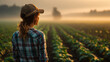 © CStock - A farmer gazes over a foggy field at sunrise, representing hard work and dedication in agriculture.