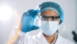 © Monmeo - Scientist in a Lab: A focused scientist, garbed in protective gear, meticulously examines a vial in a sterile laboratory setting, representing medical innovation and scientific advancement.