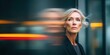 © NovaVision - Mature businesswoman with blonde hair looking thoughtful with motion blur background