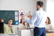 © Pixel-Shot - Male instructor with road sign giving lesson to people at driving school, back view