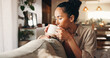 © OnPoint/peopleimages.com - Aroma, coffee and relax with woman on sofa in living room of home for break, chilling or me time. Drink, scent and wellness with calm person in apartment on weekend for beverage, rest or unwind