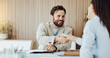 © DavidsPrime/peopleimages.com - Happy, business people and agreement with handshake for partnership, introduction or hiring in office. Businessman, woman or colleagues shaking hands with smile for b2b, meeting or job recruiting