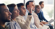© Kobus Louw/peopleimages.com - Man, raised hand and audience at conference for business people for questions, insight or feedback. Person, crowd and gesture for review, workshop or group with notes at corporate training convention