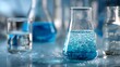 © Khalid - Blue chemistry laboratory background featuring beaker and flask filled with water, scientific experiment concept, laboratory glassware and research equipment for biotechnology and chemistry studies