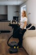 © Roman - Woman performing professional cleaning service with vacuum cleaner