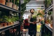 © Roman - Florist standing in plant shop holding potted plant