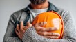 © VisualForge - Man holding an orange hard hat