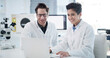 © peopleimages.com - Scientist, team and smile with laptop in lab for experiment results, medical research or innovation. Science, people or happy with tech at work for vaccine development, clinical trial or breakthrough
