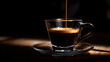 © pjjaruwan - Espresso crema being poured into clear glass cup on saucer in dark moody cafe with low key lighting creating warm highlights