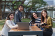 © crizzystudio - Young asian students collaborating on campus with laptop