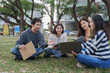 © crizzystudio - Young asian students collaborating outdoors on university campus