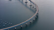 © AmazingAerialAgency - Aerial view of the graceful curve of the Coronado Bridge stretching across the bay, a ribbon of concrete and steel connecting to the distant shore, Coronado, California, United States.