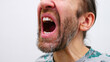 © Stockah - An open mouth of a man screaming madly