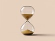 © Sumon - Elegant hourglass with golden sand flowing between clear glass bulbs against neutral gradient background representing time passage and patience