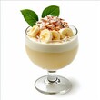 © Light of Art - Delicious banana and coconut parfait layered with cream and garnished with fresh leaves and shredded coconut in a clear glass dessert cup