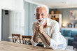 © Jelena Stanojkovic - A smiling middle-aged man looks directly into the camera while standing at the kitchen counter.