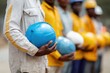 © Andrii Zastrozhnov - African male workers holding hard hats on construction site