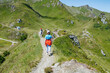 © Elena Medoks - Tourists walking on a mountain path on a sunny summer day