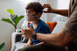 © kleberpicui - Father assisting young child during nebulizer therapy at home, showing parental care, pediatric respiratory treatment and emotional family support.