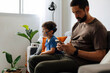 © kleberpicui - Father sitting beside child during nebulizer treatment at home, illustrating emotional support, pediatric healthcare and daily family caregiving routine.
