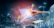 © InfiniteFlow - A businessman uses a laptop to analyze financial data with digital graphs against a vibrant city skyline at night, symbolizing growth and innovation. Impute