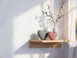 © anvcart - A sunlit minimalist shelf with heart ornaments and cherry blossom branches
