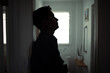 © kieferpix - silhouette of stressed man leaning against wall in bathroom, mental health and burnout concept