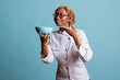 © DC Studio - Female chef holds bowl and enjoys aroma of fresh dish in studio. Young culinary professional shows satisfaction, creativity and appreciation for flavorful cooking, highlighting skill and passion.
