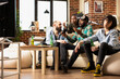 © DC Studio - Multiethnic friends express disappointment after male gamer loses virtual reality match. Diverse group reacts in frustration during casual hangout, sharing dramatic gaming moment in cozy living room.