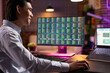 © DC Studio - Happy male entrepreneur sitting with desktop pc and laptop, analyzing financial graphs. Focused businessman works from home, studying investments and digital trading statistics on multiple screens.