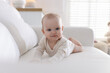 © New Africa - Cute little baby on sofa at home
