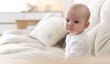 © New Africa - Cute little baby on sofa at home. Space for text