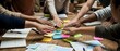 © Yuliia - Diverse team collaborating with colorful sticky notes on wooden table during creative brainstorming session for business planning and project development.