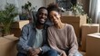 © LimeSky - Happy Black couple celebrating their new home amidst unpacked boxes smiling for the camera