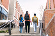 © Koldo_Studio - Group of multi ethnic students with backpacks and books ascending university stairs, looking towards a bright future and education