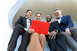 © VISTA by Westend61 - Business team smiling with red laptop in Barcelona office