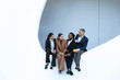 © VISTA by Westend61 - Business team collaborating and conversing in modern minimalist setting