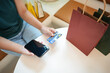 © Charlie's - Asian woman with smart phone for online shopping.  Hand holding mobile phone with Payment on credit card online shopping electronic wallet Payment Shopping by phone connected card concept