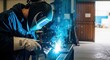 © SHANAJ - Welder at work in a workshop with protective gear