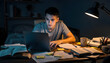 © Oleksandr - Focused student work late night on laptop, desk lamp illuminates papers, books, and coffee, emphasizing diligent study and project completion