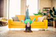 © deagreez - Young woman having fun at her bright and cozy living room with cheerful and upbeat vibes