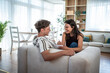 © Migma_Agency - Young couple laughing together making notes on sofa