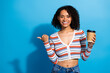 © deagreez - Young chic woman in striped cardigan smiles with coffee cup on blue background for lifestyle fashion advertising and shopping campaigns