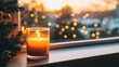 © AszmiStock - A bright candle with a warm glow on a windowsill, creating a cozy atmosphere against a blurred urban evening backdrop.