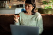 © Davor - Woman shopping online at home with credit card