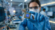 © Lukman - Scientist holding a microchip in a clean room laboratory, showcasing technological innovation and advanced research