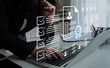 © InfiniteFlow - Woman using a laptop in a modern office with digital icons representing checklists and profiles, illustrating the job recruitment process and organizational efficiency. Gantry