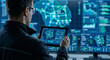 © CGI STOCKS - IT engineer using a digital tablet in a high-tech network operations control room with global data screens.