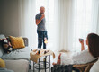 © Soloviova Liudmyla - Happy bald man standing and woman sitting in rattan chair enjoying traditional Chinese Gongfu Cha tea ceremony at home, sharing warm freshly brewed tea by bright window during relaxing domestic ritual